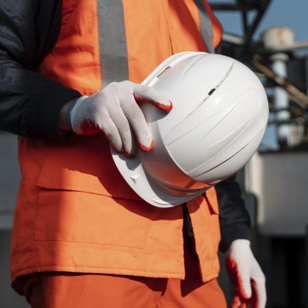 close-up-hand-holding-safety-helmet ISO 45001:2018 Occupational health and safety management systems