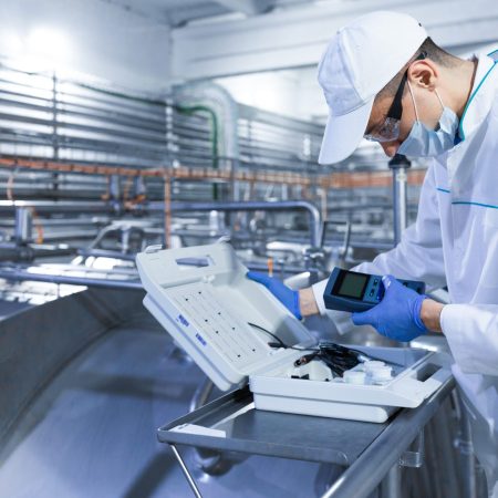 man in a white robe and a cap make a configure of device FSSC 22000 V 5.1 FOOD SAFETY MANAGEMENT SYSTEMS (FSMS)